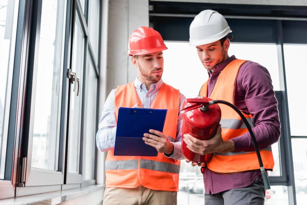 contractors inspecting fire extinguisher