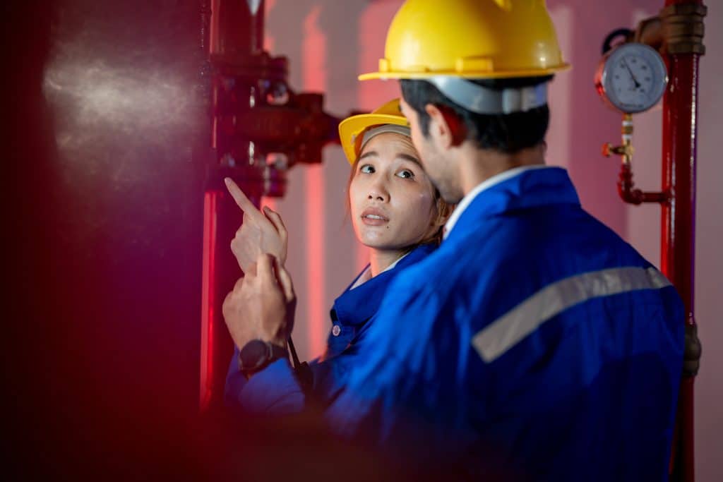 fire protection subcontractors examining pipes
