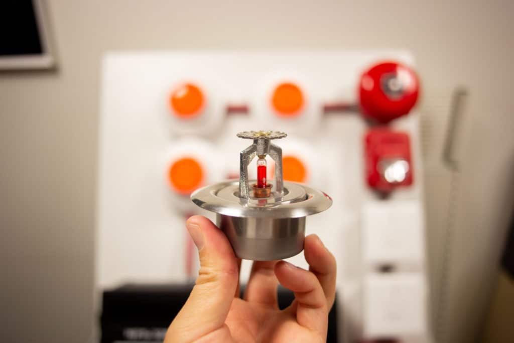 Closeup of hand holding a fire sprinkler head