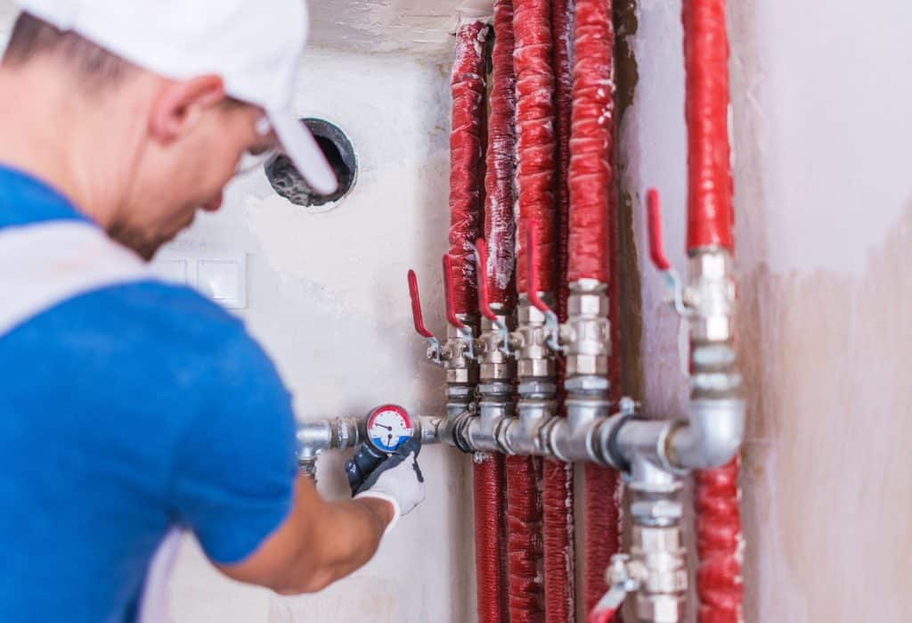 man working on fire suppression pipes